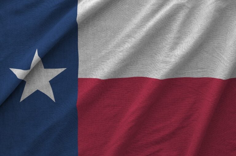 Texas us state flag depicted on folded wavy fabric of old cloth