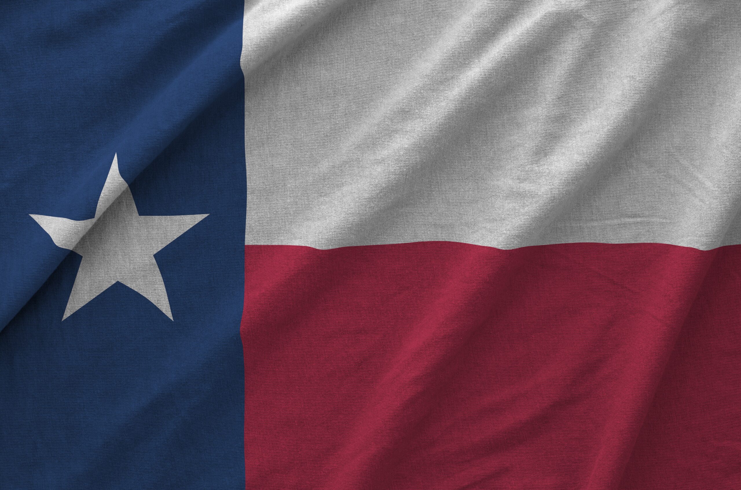 Texas us state flag depicted on folded wavy fabric of old cloth